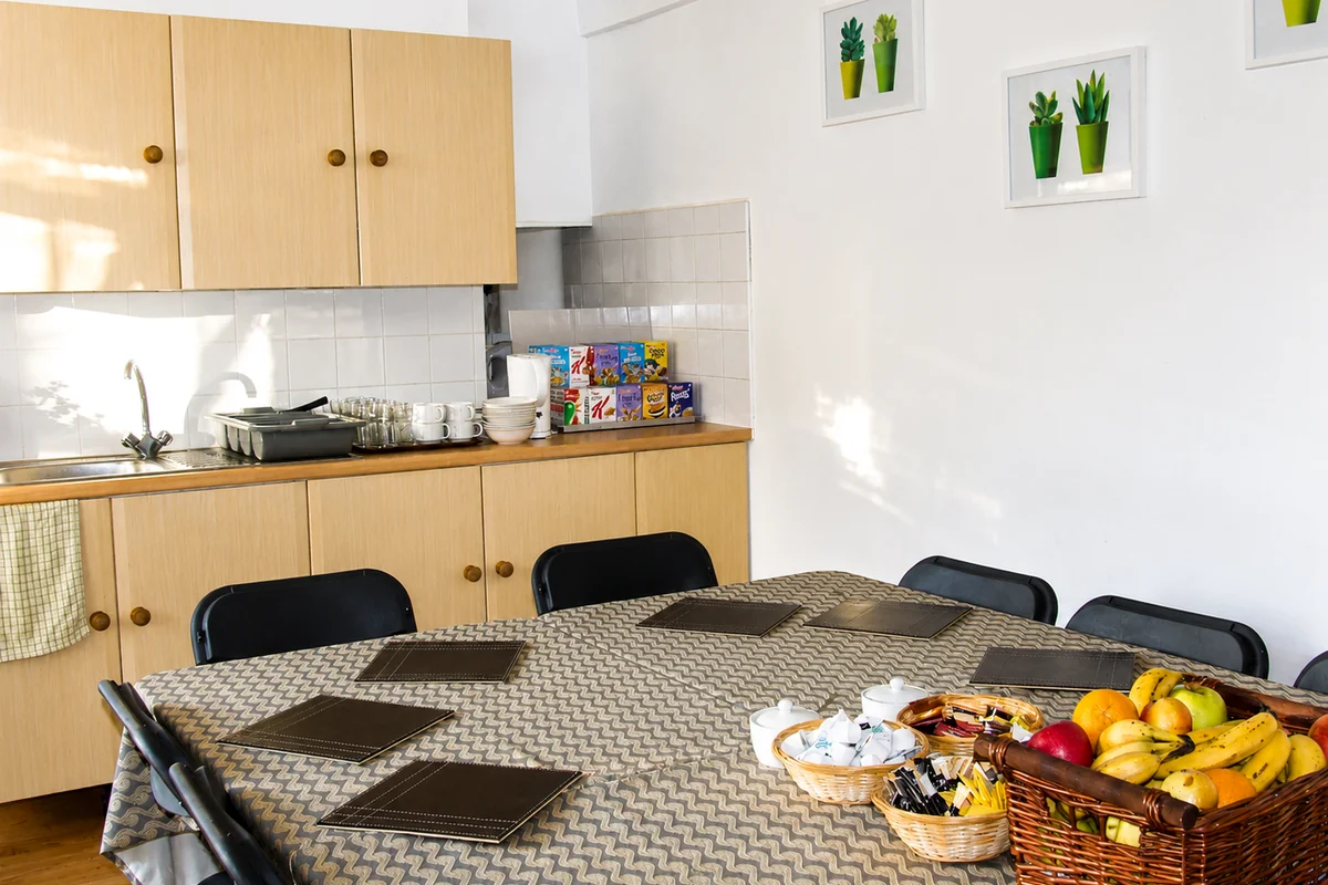 Cedars House guest dining area with table and kitchenette