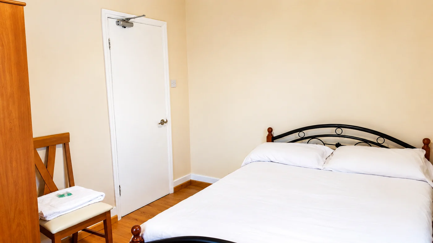 Standard Double Room bed and seating at Cedars House
